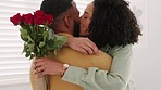 Love, wow or couple with flowers kiss or hug in celebration of a happy birthday, anniversary or valentines at home. Rose bouquet, relax or surprised black woman shocked by a romantic black mans gift