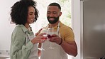 Happy black couple, kitchen and wine toast while cooking with love, hug and smile in home together. Happy couple, black people and happiness for romance, dinner or bonding for quality time in Chicago