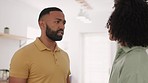 Divorce, couple fight and anger with talking, upset and unhappy in home. Young man and woman frustration, stress or argue for relationship problems, conflict or miscommunication for affair or dispute