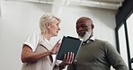 Business people, tablet and conversation working on report, reading communication or planning startup leadership strategy. Senior man, woman and discussion standing in lobby on digital tech device