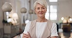 Elderly woman, face and smile with arms crossed for corporate leadership, management or vision at office. Portrait of confident senior female CEO manager smiling with crossed arms for career startup