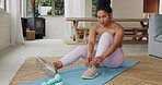 Home, workout and girl preparation with shoes tie for body training comfort with dumbbells. Health, wellness and active black woman getting ready for exercise on mat for fitness lifestyle.
