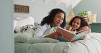 Mother and daughter reading book on a bed in a family home while happy, excited and talking about fantasy story in bedroom. Black woman and girl child together for storytelling, learning and bonding