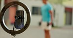 Ring light, fitness and live streaming on a fitness, exercise and gym workout for content creator. Sports training influencer filming for social media, blog and internet with phone for virtual class