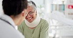 Senior woman in neck brace, doctor and consulting on injury, advice and healthcare planning in hospital with happy smile. Elderly patient or Medical expert talking, conversation and support in clinic