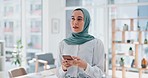 Phone, thinking and feedback with a business muslim woman typing a text message in her office at work. Contact, mobile and idea with an islamic female employee reading an email while working alone