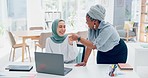 Muslim, women team and laptop with support, advice or conversation for coaching in digital marketing. Black woman, coach or mentor for islamic woman in office with fist bump, learning and celebration