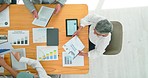 Business people, tablet and analytics on table above of graphs, charts or corporate data and statistics at the office.  Top view of marketing team hands in advertising, planning or market strategy