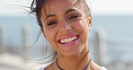 Woman, smile and portrait while outdoor on holiday at sea, ocean or water with happiness, energy and happy mindset for motivation. Face of female from Brazil in wind showing teeth while on vacation