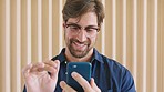 Man with glasses and phone to scroll on social media, mobile media app or on website while happy, reading and streaming online. Face of marketing male with smartphone to chat on dating network site