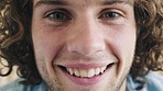 Face, smile and happy with a handsome man laughing or joking inside alone closeup with a positive attitude. Portrait, joy and carefree with a cheerful young male having a laugh with humor inside
