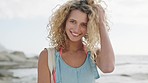 Portrait, woman and smile with curly hair at beach, summer travel and vacation, holiday or sunshine in Miami Florida. Face of happy girl relax in nature, sea and ocean for freedom, adventure or peace