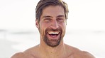 Happy man, beach and face with  smile for vacation, freedom and happiness outdoor in nature while shirtless and laughing. Portrait of funny and handsome male from London excited about holiday at sea