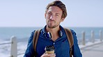 Face, man and beach for vacation, coffee and summer adventure outdoor. Netherlands male, guy and seaside for break, holiday and waterfront for weekend, relax and happiness with tea, trip and ocean.
