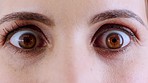 Woman, brown eyes and surprise expression with shock, fear or paranoid anxiety. Zoom on portrait, skin or vision for scared female in wow blink motion, alarm or panic for bad news with sight vision