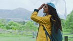 Nature, rain and woman hiking with umbrella in Brazil rainforest and jungle adventure trail. Freedom, fun and travel, happy woman in mountain and forest with smile and peace in storm in countryside.