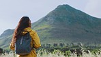 Woman, mountain and backpacking for adventure, travel or hiking journey in the countryside. Female hiker, tourist or traveler sightseeing, trip and rocky view in the nature outdoors for getaway