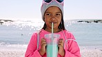 Little girl, drink and face at beach for travel holiday break with smile enjoying milkshake in Cancun. Ocean vacation and cute child enjoying beverage and relaxing in sunshine portrait.