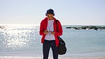 Beach, smartphone and man with headphones in selfie for social media post, profile picture and travel blog of ocean. Youth, gen z and teenager fashion with audio and cellphone photography at a sea