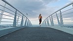 City, bridge and fitness, woman running and training for marathon race in morning workout. Motivation, freedom and health goals, urban exercise for runner girl with focus, speed and mental wellness.