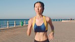Fitness, beach and woman running on path in Tokyo, training and outdoor summer workout. Exercise, health and wellness, girl runner from Japan with motivation and focus for growth at race or marathon