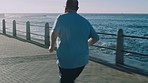Fitness, obesity and man running along beach for weight loss, challenge and body goal at sunrise. Exercise, guy and fat runner focus on cardio, change and health while on run for healthy lifestyle