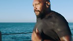 Fitness, exercise or black man running with music, podcast or radio for wellness, training or workout at beach. Ocean, bluetooth or athlete runner for marathon race, cardio health or sports event 