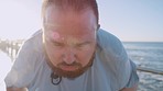 Running, tired and fitness with overweight man for losing weight, challenge and cardio endurance. Weight loss, motivation and resting with plus size runner at beach for health, wellness and stamina