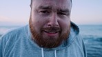 Fitness, exercise and face of tired fat man on beach promenade for cardio workout with hoodie to lose weight for obesity health problem. Portrait overweight man at sea for running, training and diet