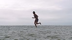 Fitness, woman and running on beach, sand and ocean for cardio exercise, healthy lifestyle or workout with speed, power and energy. Female runner, sports athlete and fast training at sea for wellness