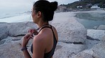 Sea, running and music of a runner woman back with headphones doing fitness workout in nature. Ocean, beach and outdoor run of a athlete streaming a podcast or web radio on exercise break by waves