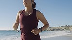 Fitness, woman and running at beach, ocean and sunshine for cardio exercise, healthy lifestyle and summer workout with focus, power and energy. Female runner, athlete at sea and training for wellness