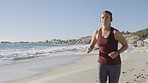Running on beach, fitness and woman with headphones for music or podcast, exercise motivation and cardio outdoor. Nature, waves and runner on beach sand, streaming and focus with training mockup.