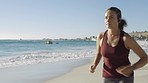 Fitness, woman and running on the beach for exercise, workout or healthy body in the outdoors. Active female runner in sports training or exercising for cardio wellness on the ocean coast in nature