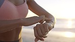 Woman, smart watch and running on sunset beach for healthcare wellness, cardiology exercise or body goals training. Runner, sports and personal trainer with time technology in sunrise nature fitness