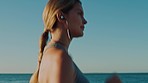Beach, earphones and woman running for exercise, health and wellness. Music, training and female runner streaming radio, podcast or audio sound while exercising, jog or workout outdoors at seashore.