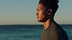 Fitness, running and man with earphones by beach, runner listening to music or podcast for motivation. Sports, sea and run with focus, profile and exercise with radio, wellness and ocean mockup.