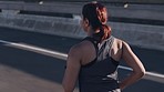 Fitness, city and woman running in the street for sport wellness, health and cardio exercise. Sports, runner and female athlete doing a workout or training outdoor in a town road for marathon or race
