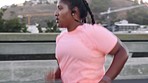 Music, fitness and plus size woman running in a road for health, wellness and cardio in a city with audio, motivation and mindset. Radio, run and curvy girl runner on highway, training and workout