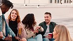 Couple of friends, bonding and rooftop drinking in New Year celebration, party event or social gathering birthday. Smile, happy and talking men, women or people diversity and alcohol drinks at sunset