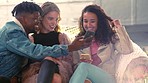 Group of friends, party and smartphone for social media, connectivity and communication. Young people, smile and phone for posting, share pictures and enjoy festival for weekend break and event.