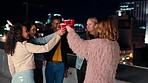 Rooftop, cheers and woman with friends at a party, event or celebration with drinks in the city. Toast, fun and woman blowing kiss while drinking with people at balcony or terrace restaurant in town.