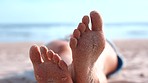 Beach, sand and feet of relax woman in sunshine on travel holiday, summer vacation or adventure in Bali. Ocean sea, relaxing wellness and freedom, peace or foot outdoor for tropical stress relief
