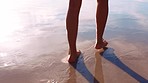 Woman feet, beach sand and walking in water for freedom, travel and peace on summer vacation while barefoot and running from waves. Legs of female on holiday at sea to relax and have fun in nature