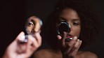 Black woman, makeup and round mirror in hands for skincare, cosmetics and natural beauty on black background. Reflection, studio and model face looking in mirror for aesthetics, cosmetology or vanity