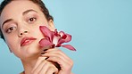 Beauty, skincare or face of woman with flower in studio for body wellness, luxury spa and skin health. Aesthetic, facial and female with plant for natural treatment, orchid products and cosmetics