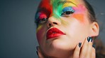 Shadow, light and face of woman with paint, facial art design  or creative cosmetics makeup for beauty, creativity and individuality. Dark lighting, painter and portrait of model with unique color