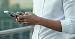 Phone, buildings and hands of businessman typing digital email, networking online and contact social media user. Urban city, mobile website app and worker doing 5g internet search on New York rooftop