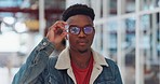 Face, fashion and black man take off glasses while standing with cool, stylish or trendy clothing. Portrait, aesthetic and young creative male from Nigeria with designer jacket, spectacles and outfit