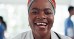 Happy, smile and face of a doctor in the hospital lobby after healthcare or medic consultation. Happiness, excited and portrait of black woman medical nurse standing in the hallway of medicare clinic